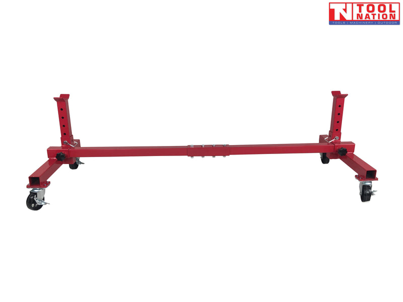 Front view of red mobile car axle dolly with extended center beam, upright supports, and caster wheels