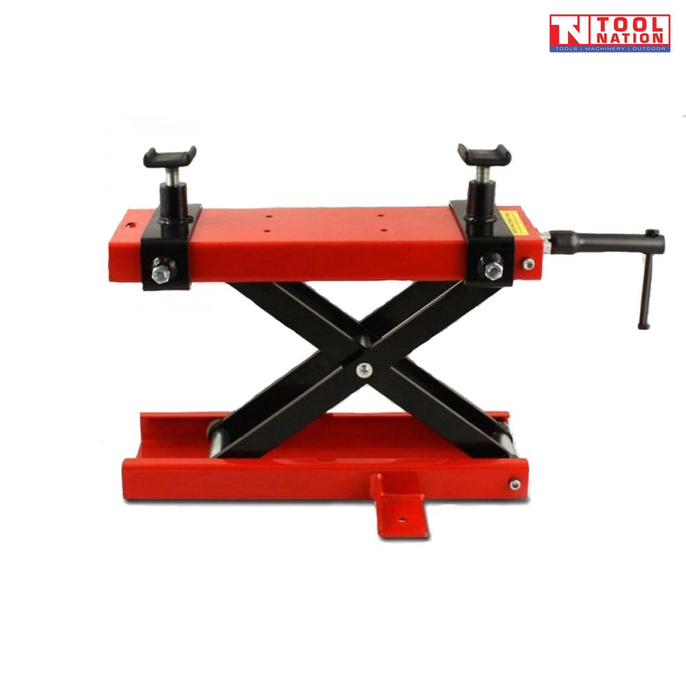 Mini motorcycle scissor lift with black scissor frame and red top platform shown lowered on a light grey background