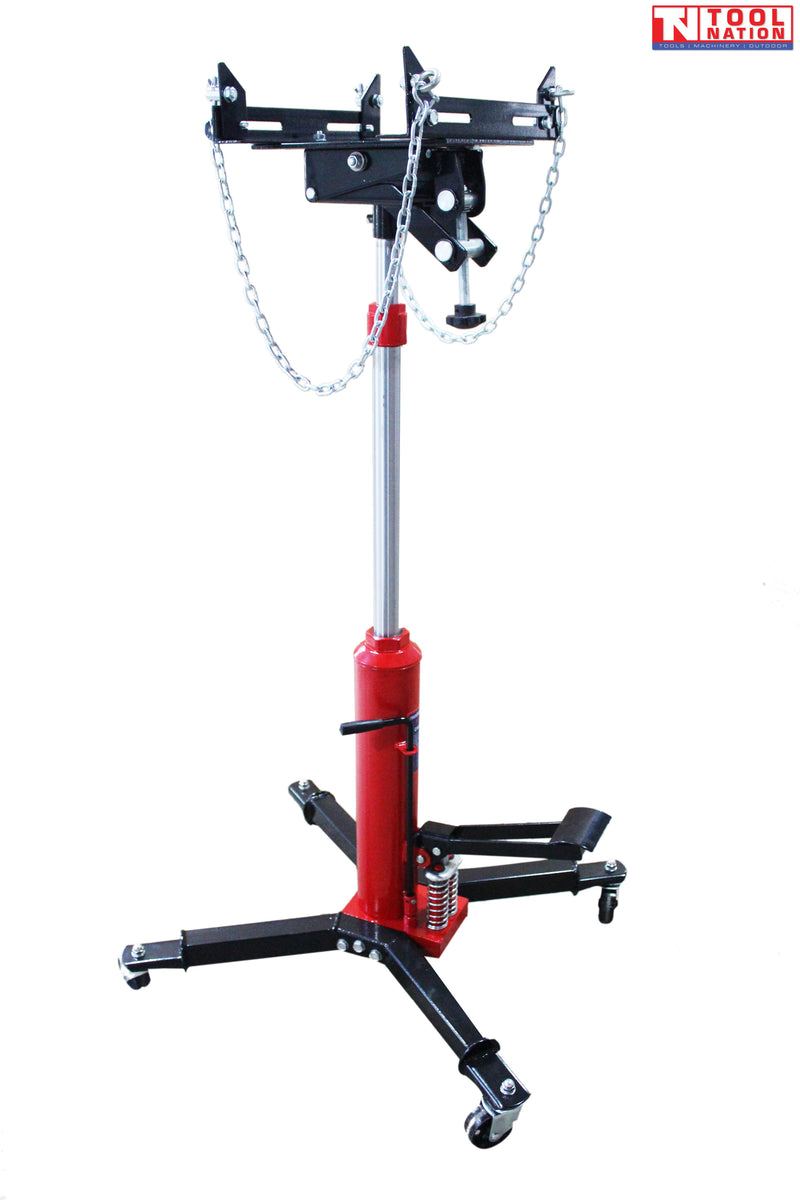 Transmission jack with red hydraulic column, black adjustable saddle, safety chains, foot pedal, and four caster legs
