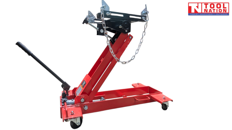 Front view of red hydraulic floor transmission jack with black saddle plate, safety chains, and handle