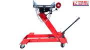 Angled side view of red hydraulic floor transmission jack with black saddle plate, safety chains, and handle