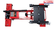 Low side view of red hydraulic floor transmission jack with black saddle plate, safety chains, and handle