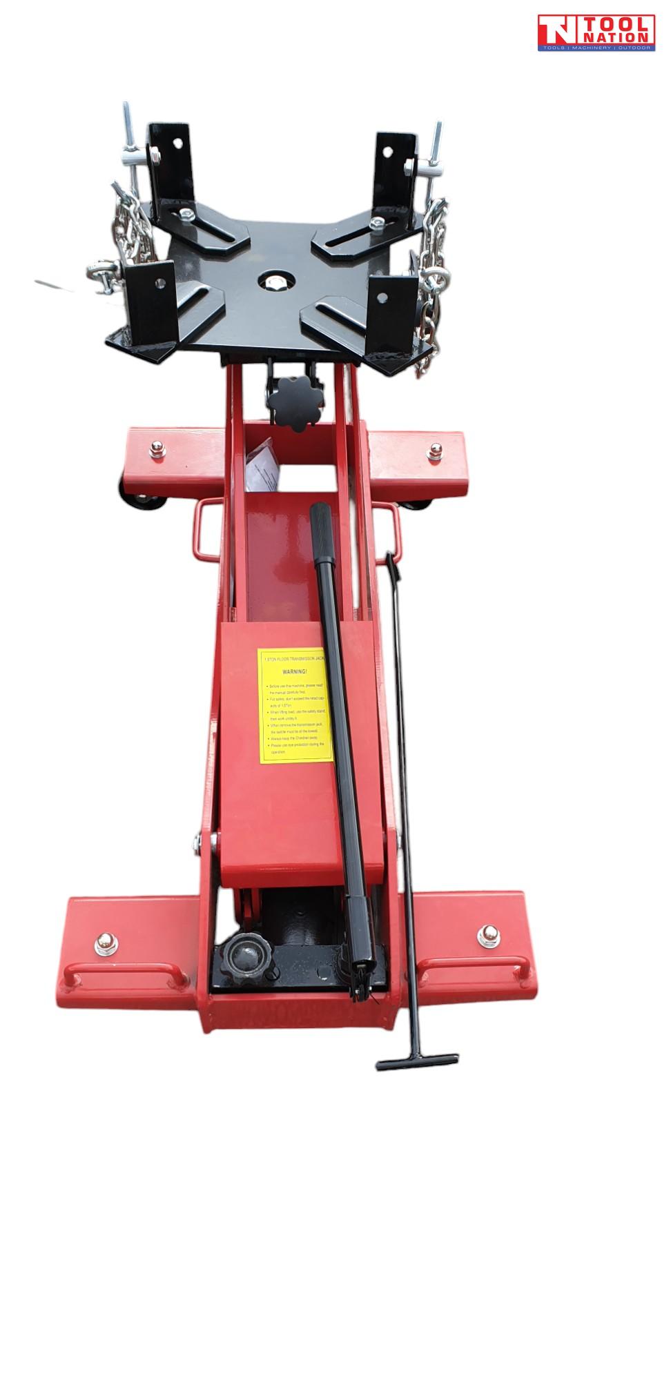 Front view of red floor transmission trolley jack with black saddle plate, safety chains, and handle