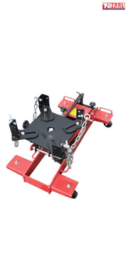 Angled top view of red floor transmission trolley jack with black saddle plate, corner brackets, and safety chains