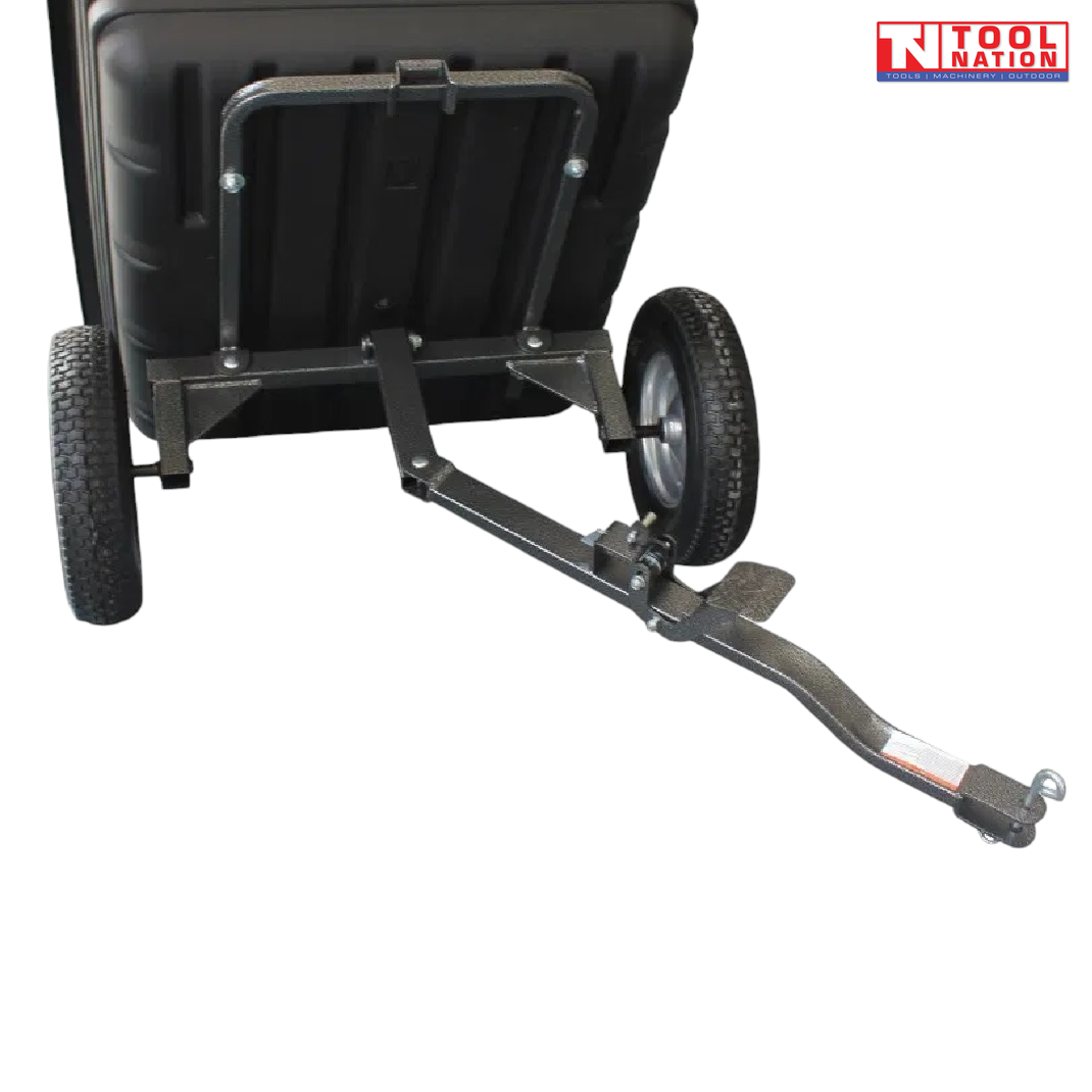 Close-up rear view of a black tow-behind dump cart showing the underside frame, long drawbar, metal pin and two treaded wheels.