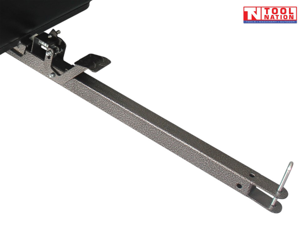 Close-up of a black tow bar assembly with metal pin, latch, foot pedal and part of the cart tub visible.