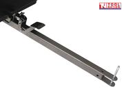 Close-up of a black tow bar assembly with metal pin, latch, foot pedal and part of the cart tub visible.