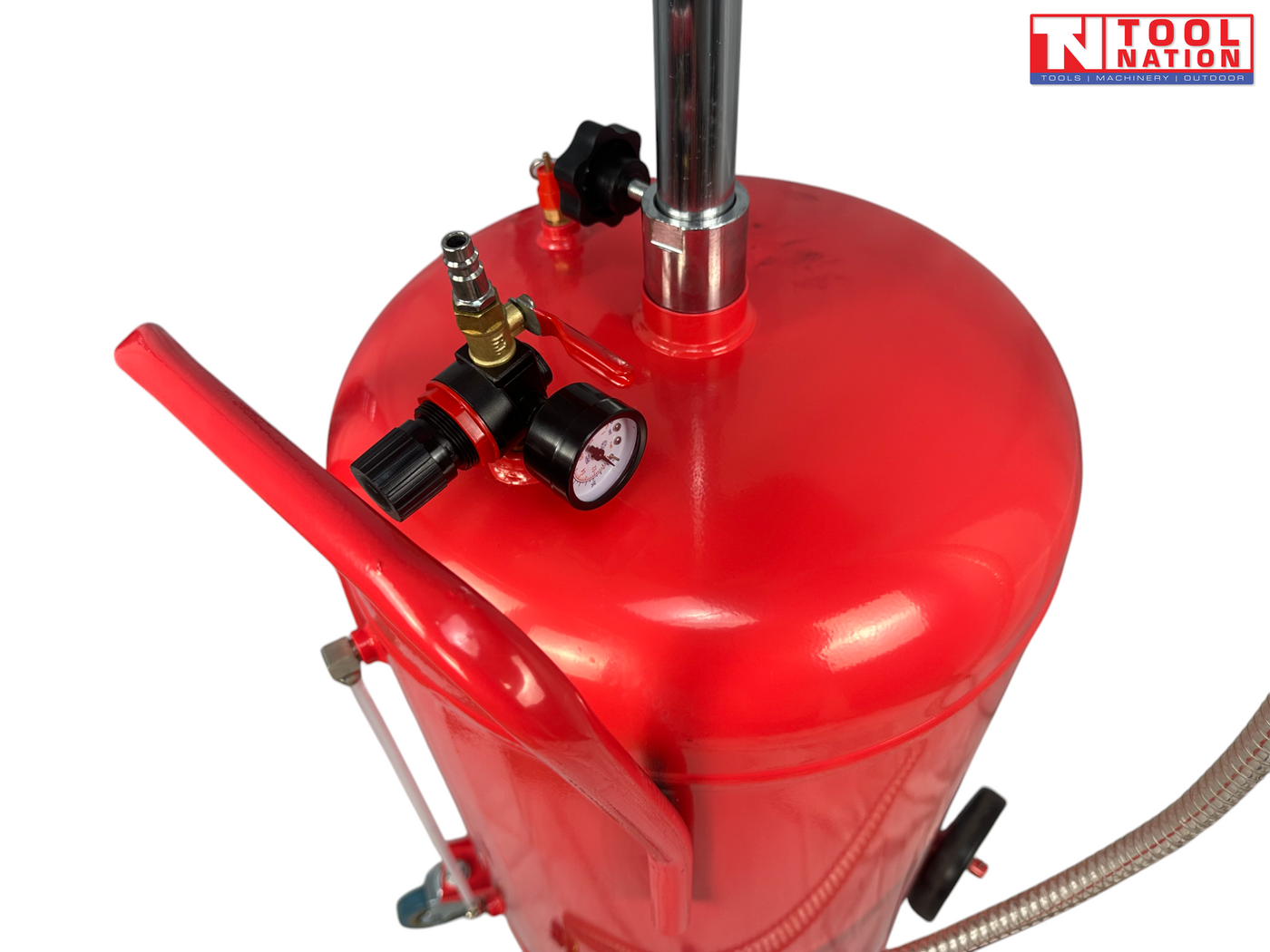 Close-up of red oil drainer tank top with pressure gauge, valve fittings, and chrome support tube