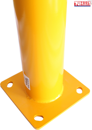 Close-up angled view of a yellow bollard base showing the cylindrical post, square mounting plate, four mounting holes, label and Tool Nation logo.