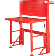 Front angled view of red fold-up workbench with pegboard back panel, hooks, and fold-out bench legs