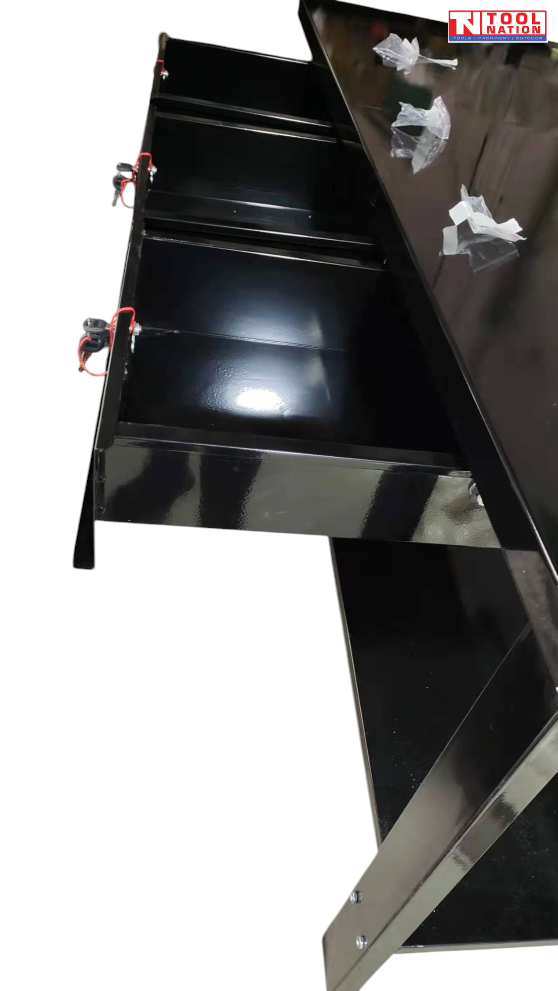 Side close-up of black steel workbench showing side panel and drawer unit.