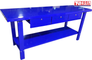 Angled front view of blue steel workbench with three drawers and lower shelf.