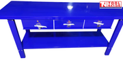 Front view of blue steel workbench with three drawers and full-width lower shelf.