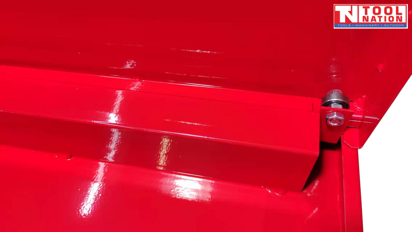 Close-up of red drawer slide and roller mechanism under the workbench top.