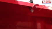 Close-up of red workbench latch and fastener under the bench top.