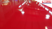 Close-up of glossy red workbench top surface.