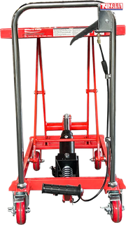 Rear view of a red hydraulic lift table cart with raised scissor frame, chrome handle, wheels, foot pedal, and release lever.