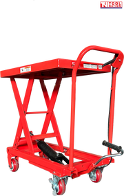 Angled view of a red hydraulic lift table cart with raised scissor frame, handle, wheels, foot pedal, and labels.