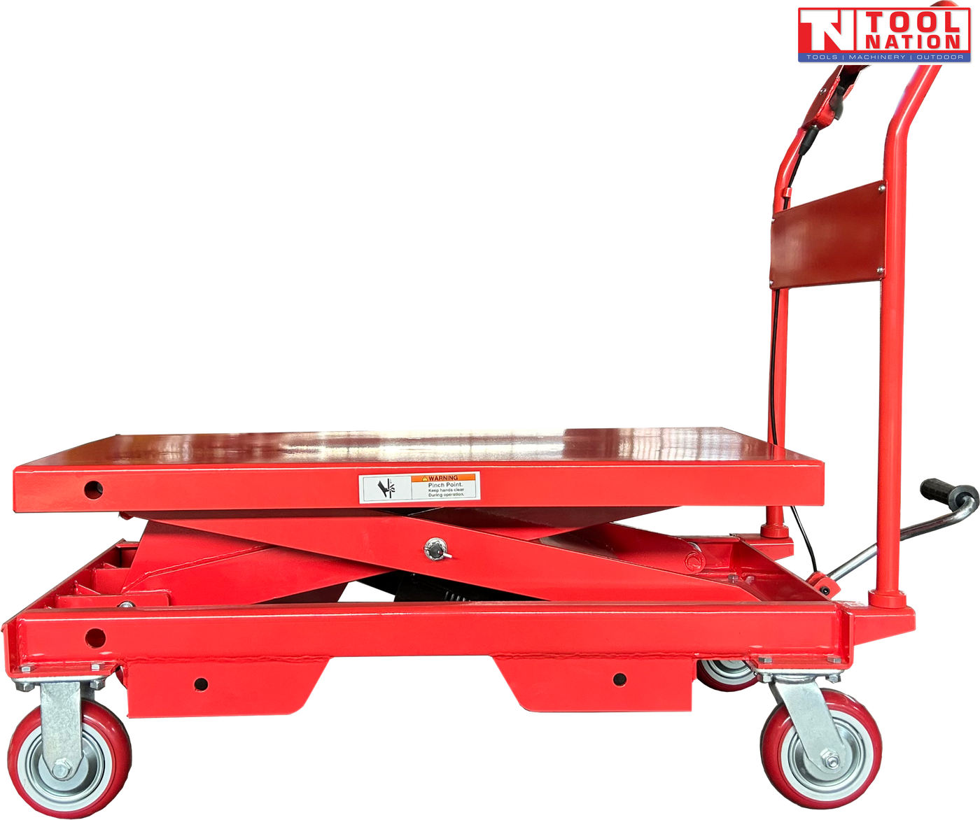 Side view of a red hydraulic lift table cart with lowered platform, handle, wheels, foot pedal, and warning label.
