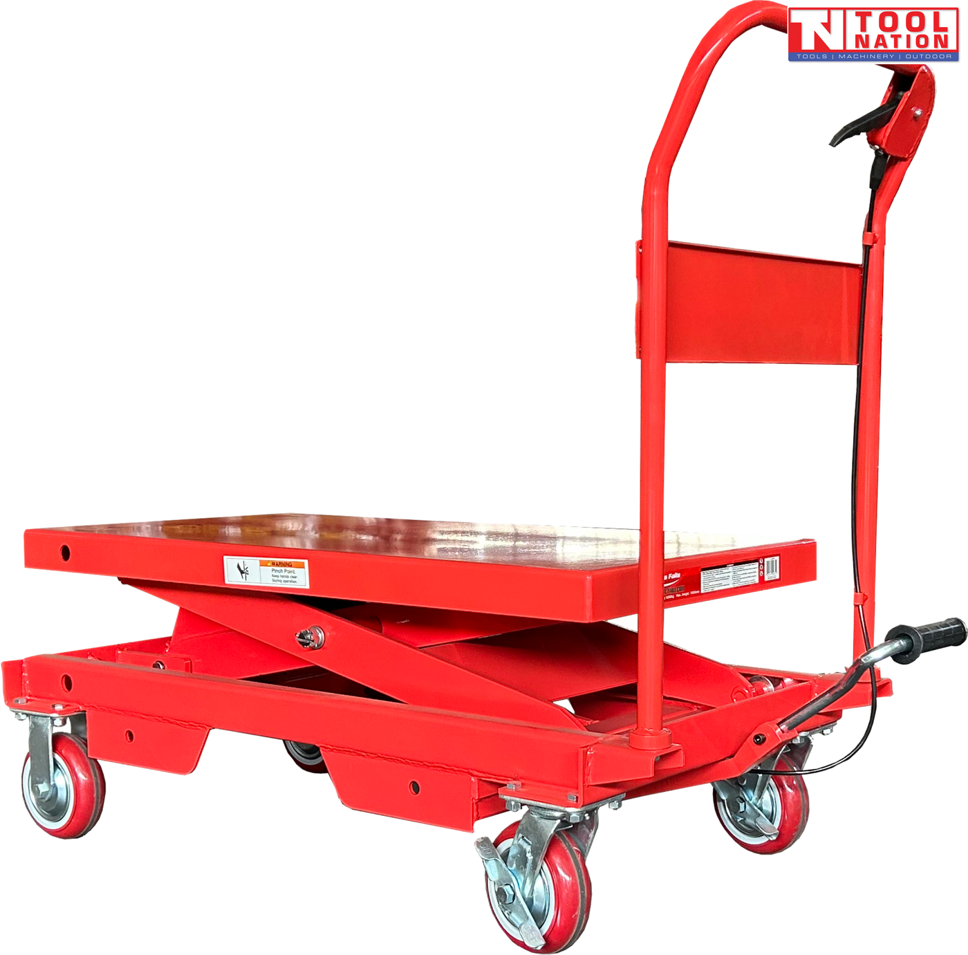Angled view of a red hydraulic lift table cart with lowered platform, handle, wheels, foot pedal, and warning labels.