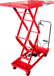Red hydraulic lift table cart with raised double scissor frame, handle, wheels, foot pedal, and visible capacity text.