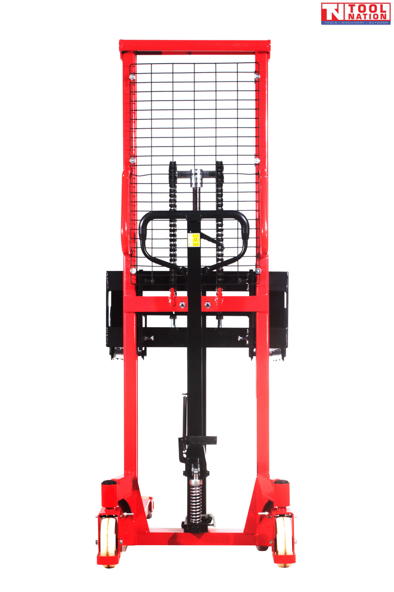 Front view of a red pallet stacker with black handle, mesh guard, chain mechanism, forks, and wheels.