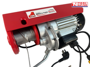 Close-up angled view of a red electric hoist showing the cable drum, motor housing, label, and power cord.